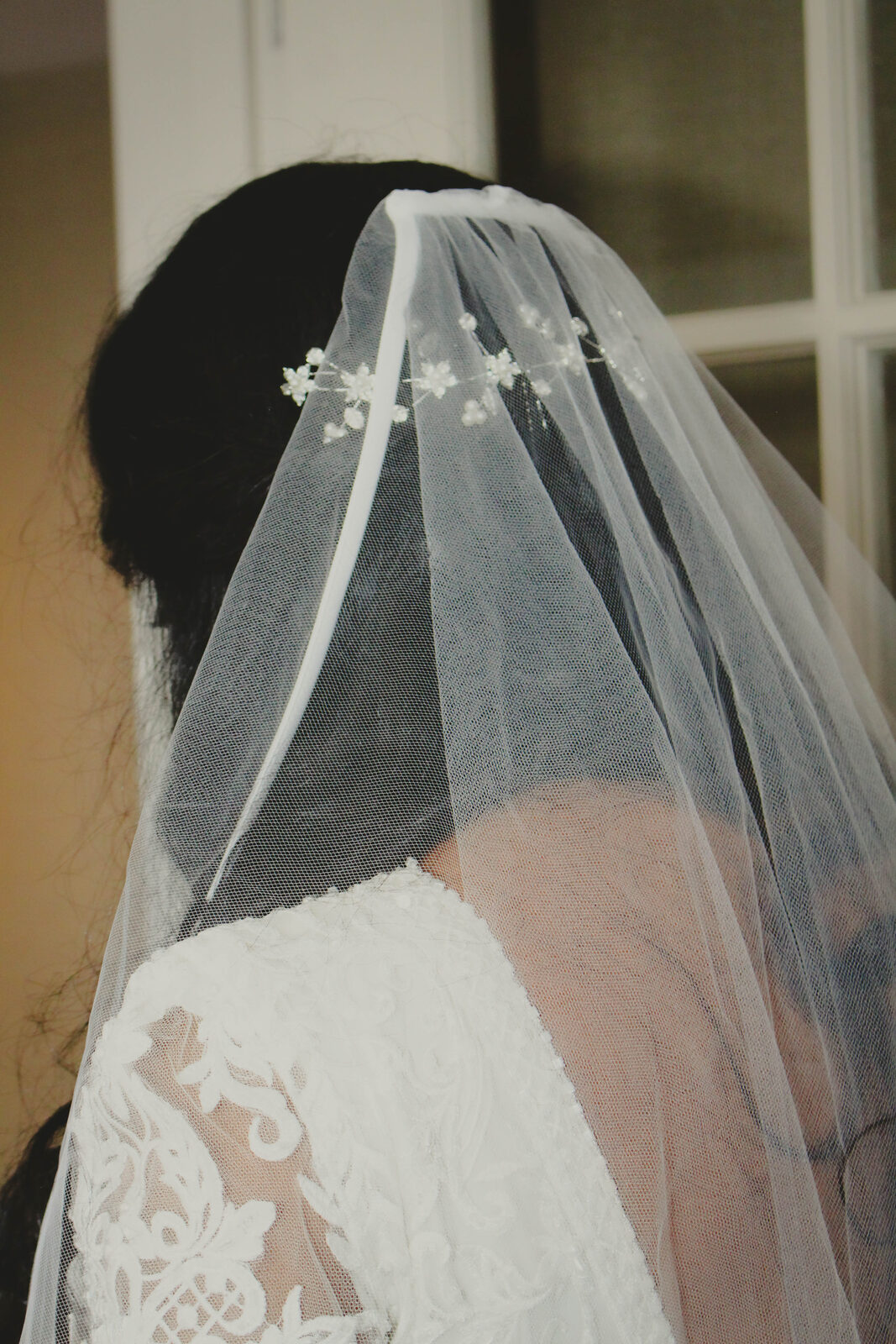 Bride's lace veil from behind