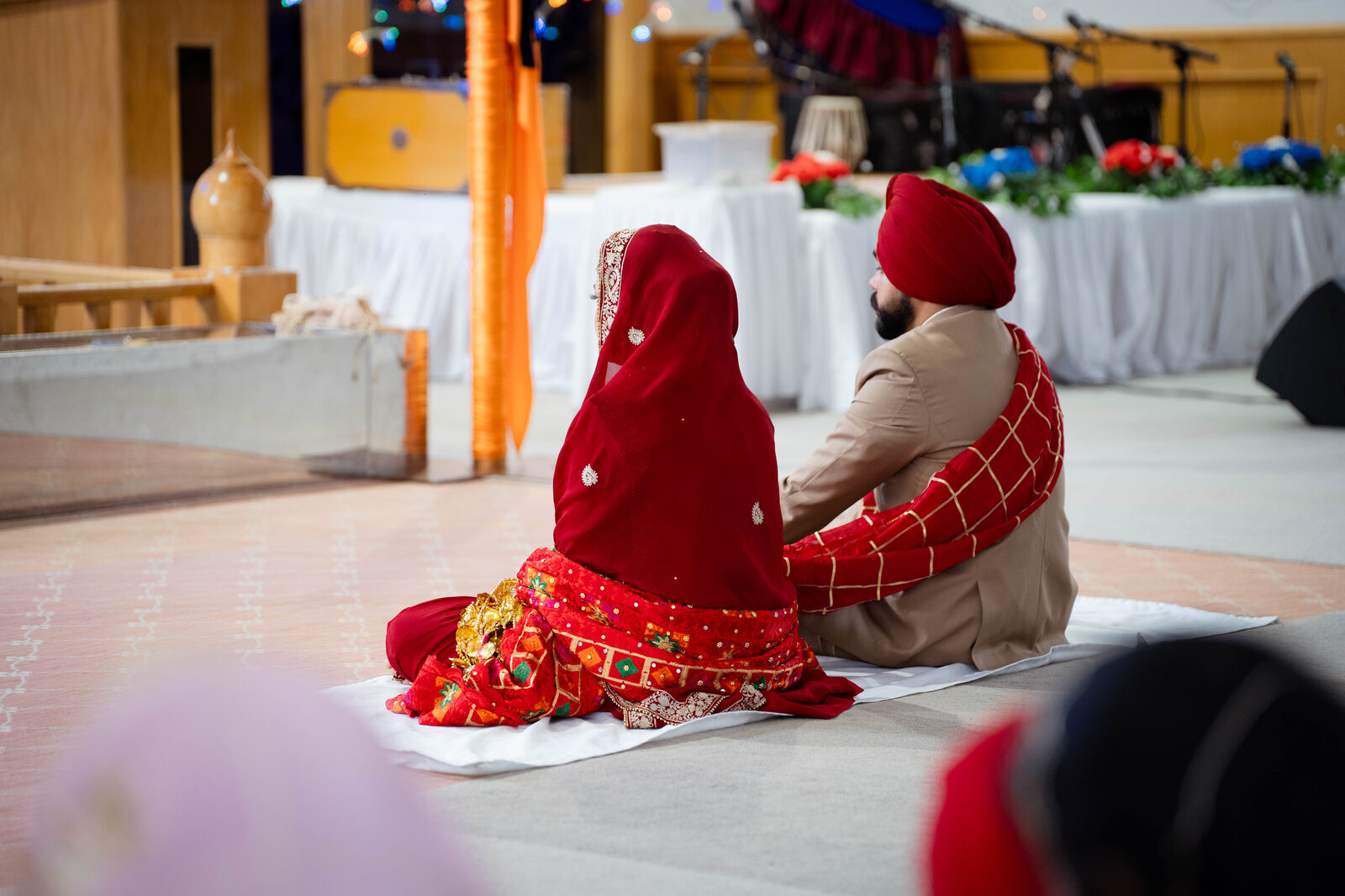 Bride and groom seated together during the ceremony